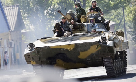 An armoured vehicle manned by pro-Russian rebels leaves Donetsk in the direction of the MH17 crash site