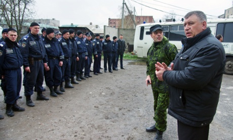 Igor Bezler, in green fatigues and without his walrus moustache, is at a briefing of policemen in Gorlovka. 