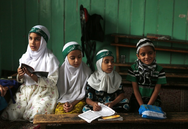 Kashmiri Muslim children attend a class where they learn verses of the Koran