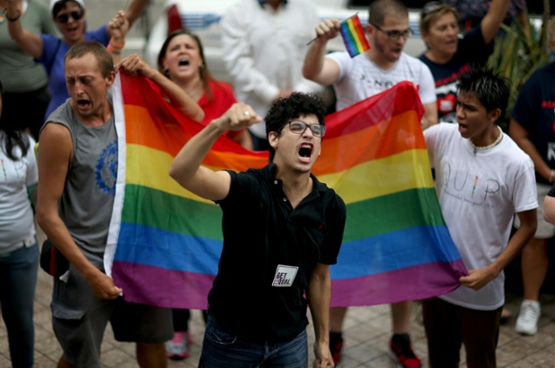 A protester shows his support for LGBTQ couples who are asking the state to recognise their marriage