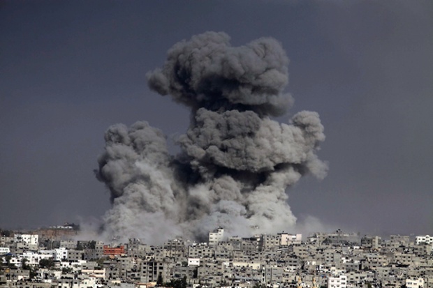 Smoke trails over Gaza city after Israeli shelling.