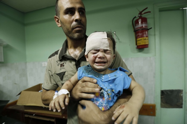 A Palestinian child, wounded in an Israeli strike