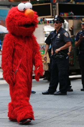 A person dressed as the Sesame Street character Elmo walks through Times Square in New York