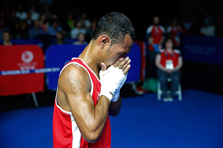 boxing: Charles Keama of Papua New Guinea dejectedly walks out of the arena