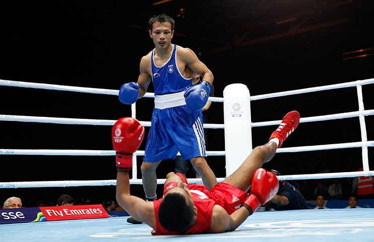boxing: Aqeel Ahmed of Scotland gets knocked down by Devendro Laishram 