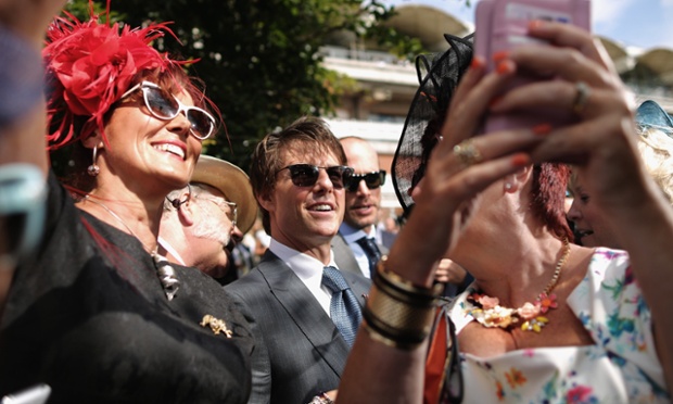 A group of women take 'selfies' with Actor Tom Cruise at Goodwood on July 31, 2014 in Chichester, England. Today is Ladies Day at the prestigious Goodwood Races.