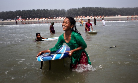 New wave … young girls surfing at Cox's Bazar, Bangladesh.