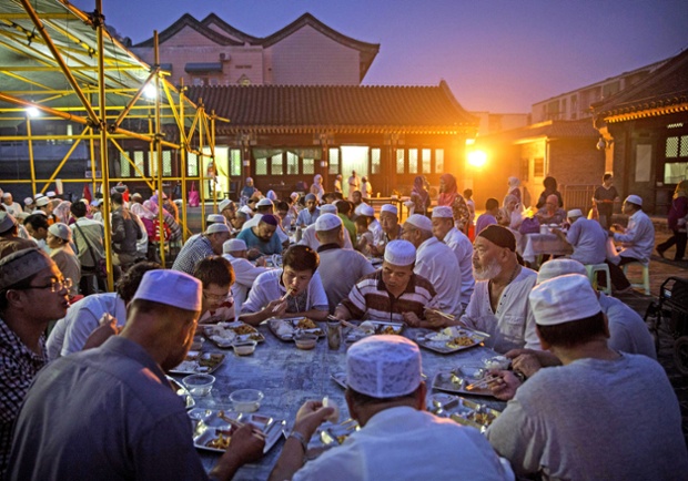 Chinese Muslims eat at dusk during Ramadan at the historic Niujie Mosque in Beijing, China