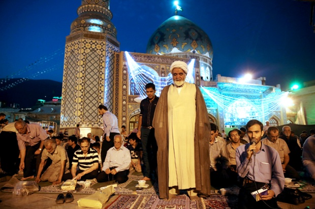 An Iranian clergyman prays in northern Tehran, Iran