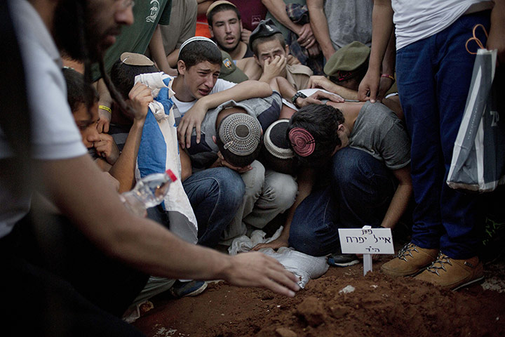 20 photos: Friends of the three Israeli teenagers mourn during their funeral in Modiin