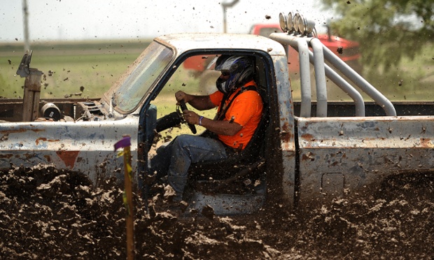 Roscoe, Texas: Jason Kennemur drives through mud during his run in the Plowboy Mud Bog.