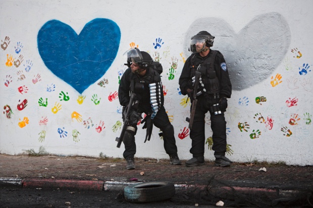 Ar'ara:, Israel: Israeli riot police officers take positions during clashes with Palestinians.