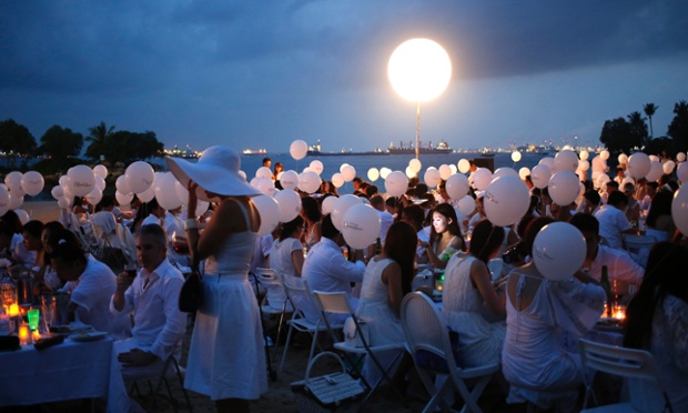 Singapore: Diners at the Dinner in White picnic at Tanjong Beach in Sentosa.