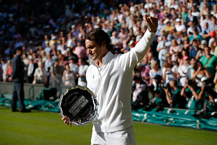 Wimbledon 13: Federer looks close to tears as he holds the runner-up trophy