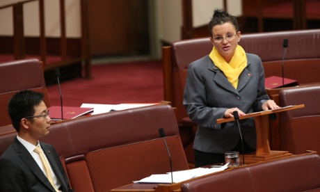 Tasmanian PUP senator Jacqui Lambie speaks in the senate, watched on by fellow senator Dio Wang.