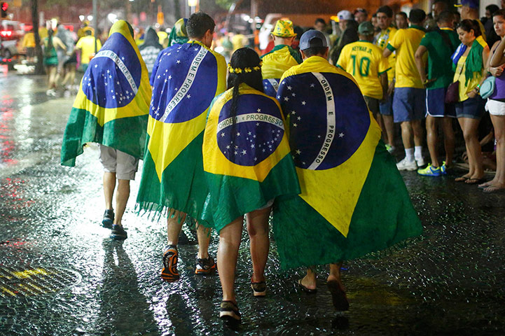 Mourning Brazil: Brazil football fans walk in the rain