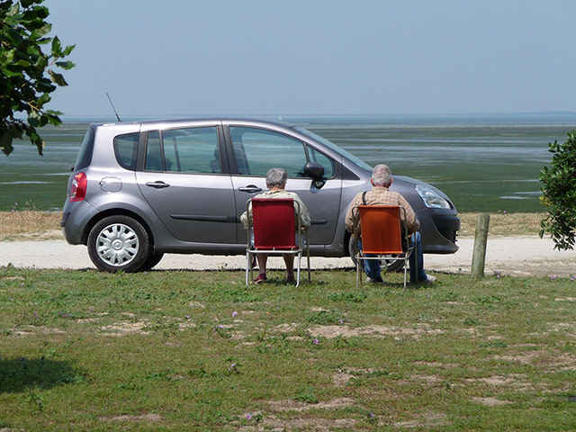 Your Pictures: Sunbathe: Two people sitting in the sun infront of a car