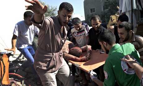 Emergency responders carry a man found under the rubble of his house, following an Israeli airstrike