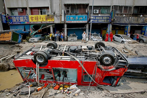 Here a fire truck lies overturned in a crater caused by the explosions.