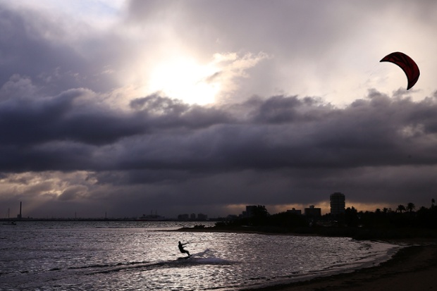 As another late afternoon cold front passes over the St.Kilda foreshore in Melbourne, Australia kite Surfers make most of the conditions.