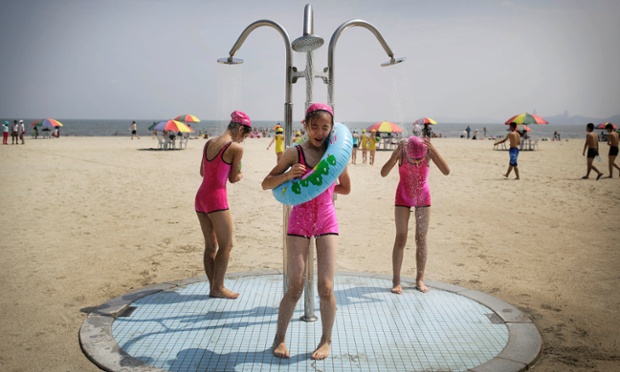 North Korean girls in similar bathing suits stand under a shower at the Songdowon International Children's Camp, Tuesday, July 29, 2014, in Wonsan, North Korea. The camp, which has been operating for nearly 30 years, was originally intended mainly to deepen relations with friendly countries in the Communist or non-aligned world. But officials say they are willing to accept youth from anywhere - even the United States.