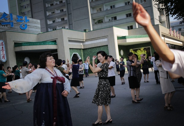 North Koreans  dance in downtown Pyongyang, Sunday, July 27, 2014 in North Korea. North Koreans celebrated the 61st anniversary of the armistice that ended the Korean War.