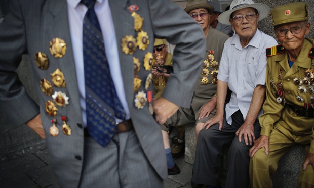North Korean war veteran, Kim Hak Chol, 81, a retired soldier, right, together with other veterans decorated with medals, attend a parade to celebrate the anniversary of the  Korean War armistice agreement, Sunday, July 27, 2014, in Pyongyang, North Korea. North Koreans gathered at Kim Il Sung Square as part of celebrations for the 61st anniversary of the armistice that ended the Korean War.