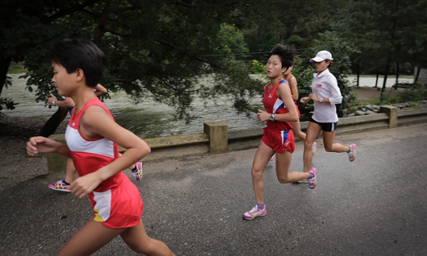 North Korean girls jog in the early evening Saturday, July 26, 2014 in the North Pyongan Province, North Korea.