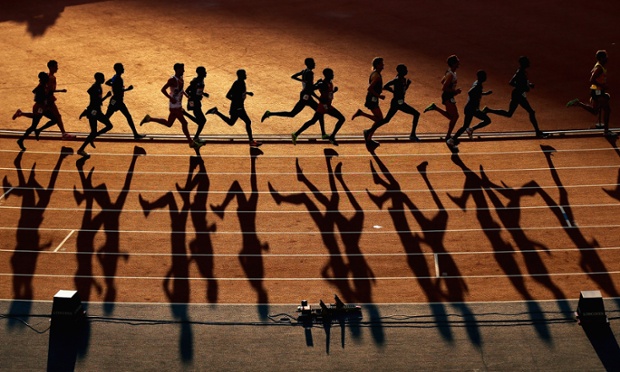 Long shadows are cast as athletes compete in the Men's 10,000 metres final at Hampden Park during day nine of the Glasgow 2014 Commonwealth Games.