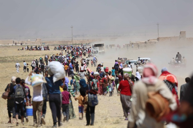 Mosul, Iraq: Tens of thousands of refugees, mostly of the Yezidi faith, who were previous trapped Mount Sinjarar escorted to safety by Kurdish Peshmerga forces. The refugees were fleeing the advance of Islamic State (Isis) forces through Iraq.