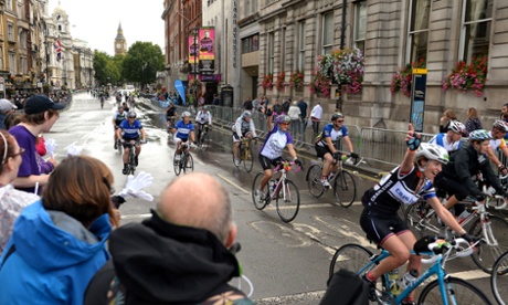Cyclists make their way down Whitehall at the end of the Ride London 100.