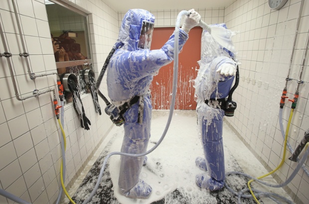 Medical professionals demonstrate the decontamination procedure as part of ebola treatment capability at Charite hospital in Berlin