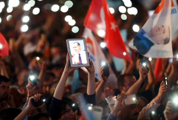 A supporters displays a picture of Turkey's prime minister Tayyip Erdogan on a tablet during celebrations of his election victory in Ankara
