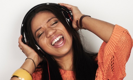 A woman listening to music through headphones