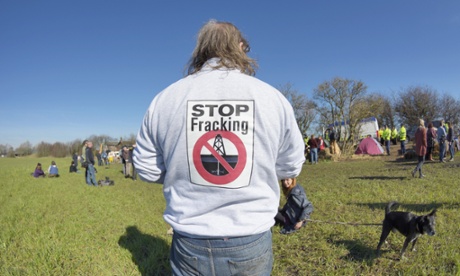 Anti-fracking protestor watching the protest on Barton Moss Road which has been blocked by two protestors using a lock-on device, Manchester, 11 March 2014.