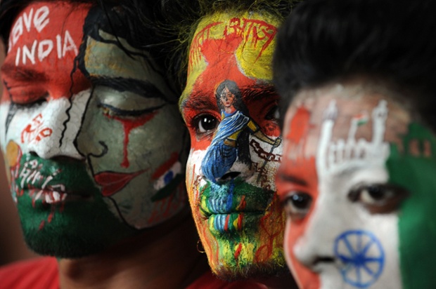 Students painted faces on the eve of India's Independence Day in Mumbai today