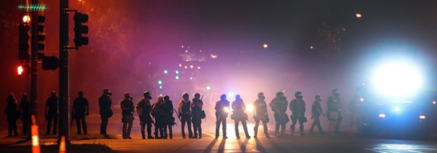 Police line the roads after another night of unrest in Ferguson, St. Louis
