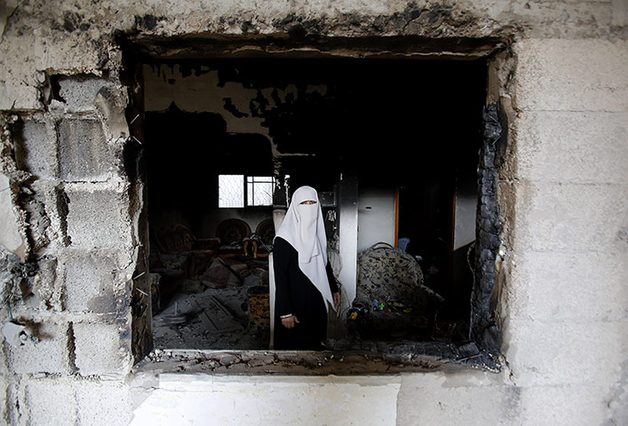 20 Photos: A Palestinian woman stands in the rubble of her destroyed home in Gaza City