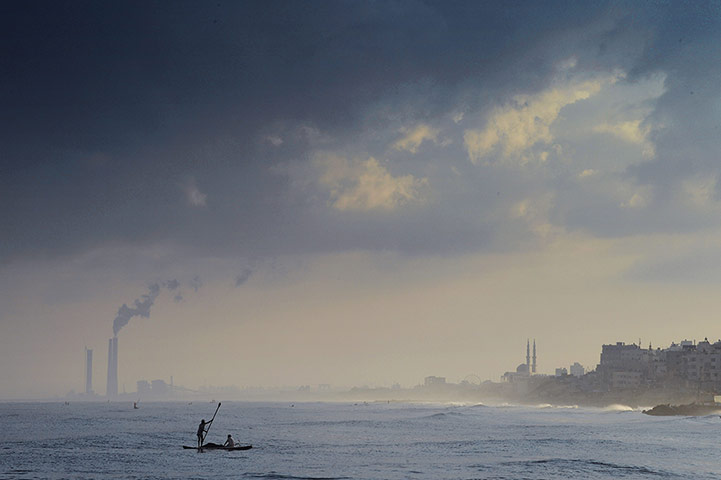 20 Photos: Two Palestinian fishermen cast their nets near the beach in Gaza City