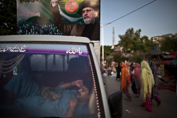 A supporter of anti-government cleric Tahir-ul-Qadri, sleeps during a protest in Islamabad