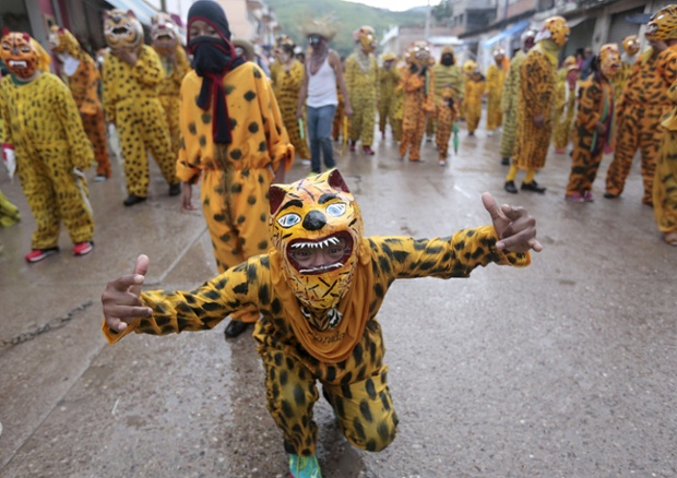 People dress as tigers to ask for rain and plentiful crops, in Chilapa, Mexico.