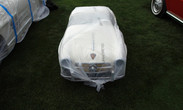 A GEBR IHLE microcar manufactured to look like a Mercedes-Benz is wrapped in plastic at The Quail, A Motorsports Gathering car show in Carmel, California.