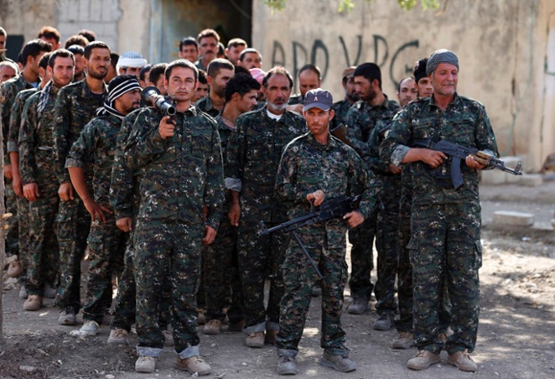 Volunteers from the Yazidi sect learn how to handle a weapon during a training camp in Qamishli, northeastern Syria on the border with Kurdistan.
