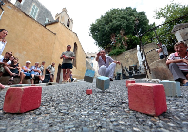 A competitor strikes a boule at the square boules world championship in Cagnes, France.
