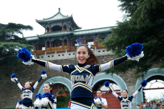 Cheerleaders dance before the Men's Triathlon medal ceremony during the Summer Youth Olympic Games in Nanjing, China