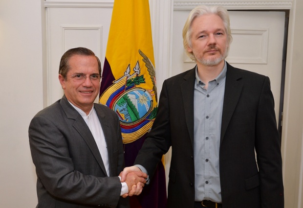 Ecuador's foreign minister Ricardo Patino shakes hands with WikiLeaks founder Julian Assange after a press conference inside the Ecuadorian Embassy in London, where Assange confirmed he 