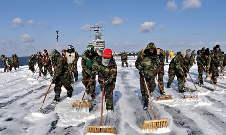 Sailors scrub the deck of the USS Ronald Reagan to remove potential radiation contamination following the Fukushima nuclear disaster. Photograph: Handout/Getty Images