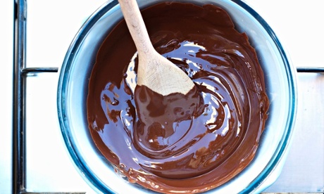 A pan of melted chocolate on cooker