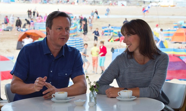 On holiday again: David Cameron and his wife Samantha pose for a photograph at the Surfside cafe on Polzeath beach, during their holiday in Cornwall.