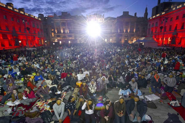 People wear E.T masks during E.T Film4 Summer Film Screening at Somerset House, London.